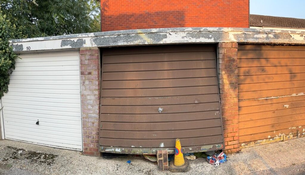 Rat infested garage when we first arrived on scene. The door is slightly opened with some rubbish preventing the garage door from completely closing,