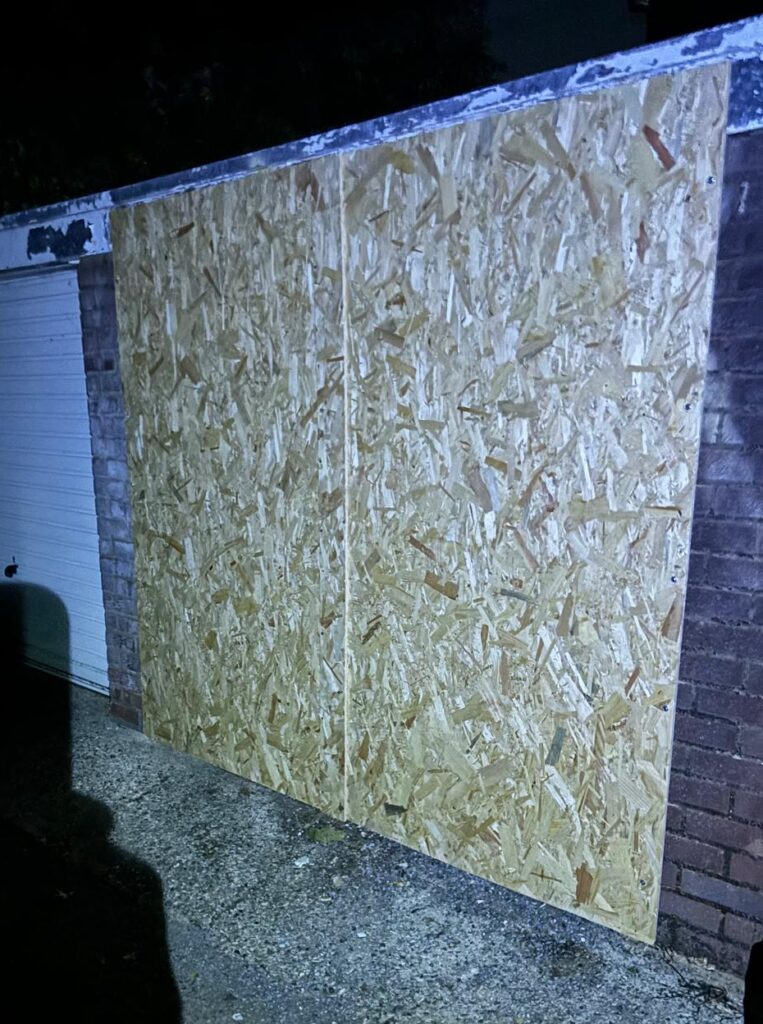 The rat infested garage after being boarded up. There is now